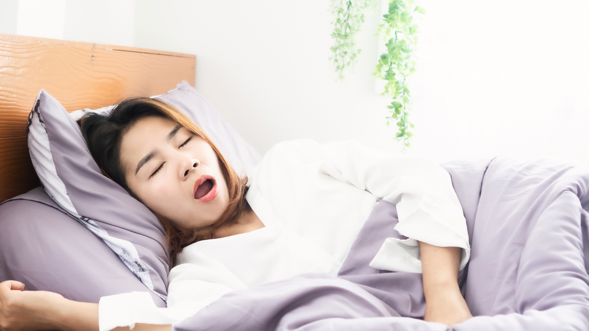 Woman Snoring While Sleeping In Bed