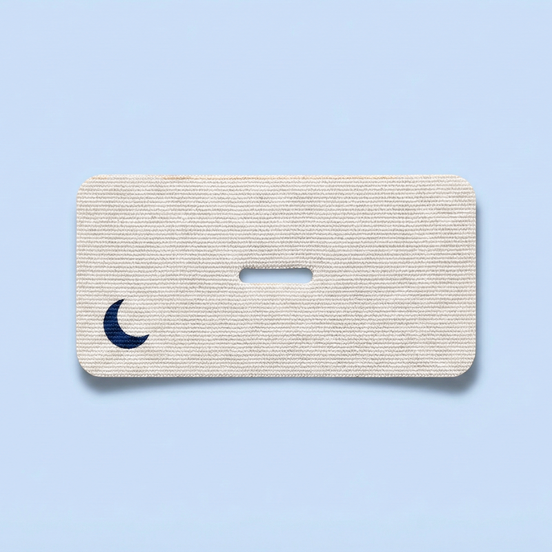 A single strip of ZQuiet Breathe Mouth Tape on a blue background