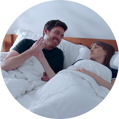 round image showing a couple waking up happy after using ZQuiet Advance